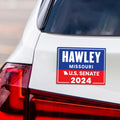a sticker on the back of a white car