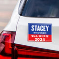 a bumper sticker on the back of a white car