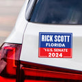 a sticker on the back of a white car