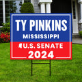 a yard sign with a house in the background