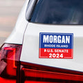 a bumper sticker on the back of a white car