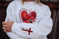 Heart Cross Valentine Jesus Sweatshirt, We Love Because He First Loved Us Tee, Valentine Bible Verse Sweatshirt, Front Sleeve
