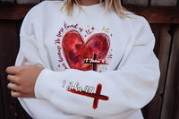 Heart Cross Valentine Jesus Sweatshirt, We Love Because He First Loved Us Tee, Valentine Bible Verse Sweatshirt, Front Sleeve