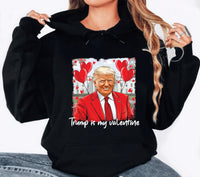 a woman wearing a black trump is my valentine hoodie