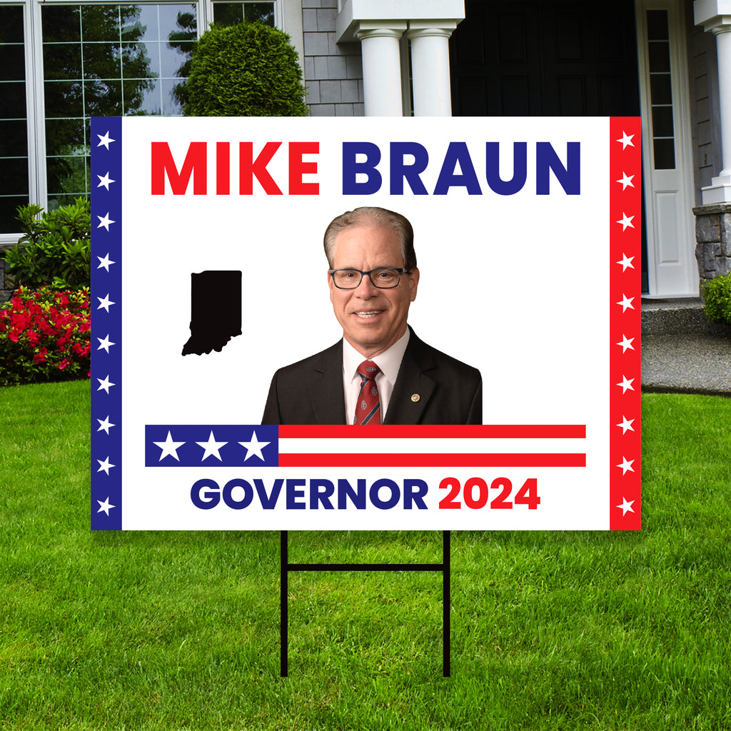 a political yard sign with a picture of a man in a suit and tie