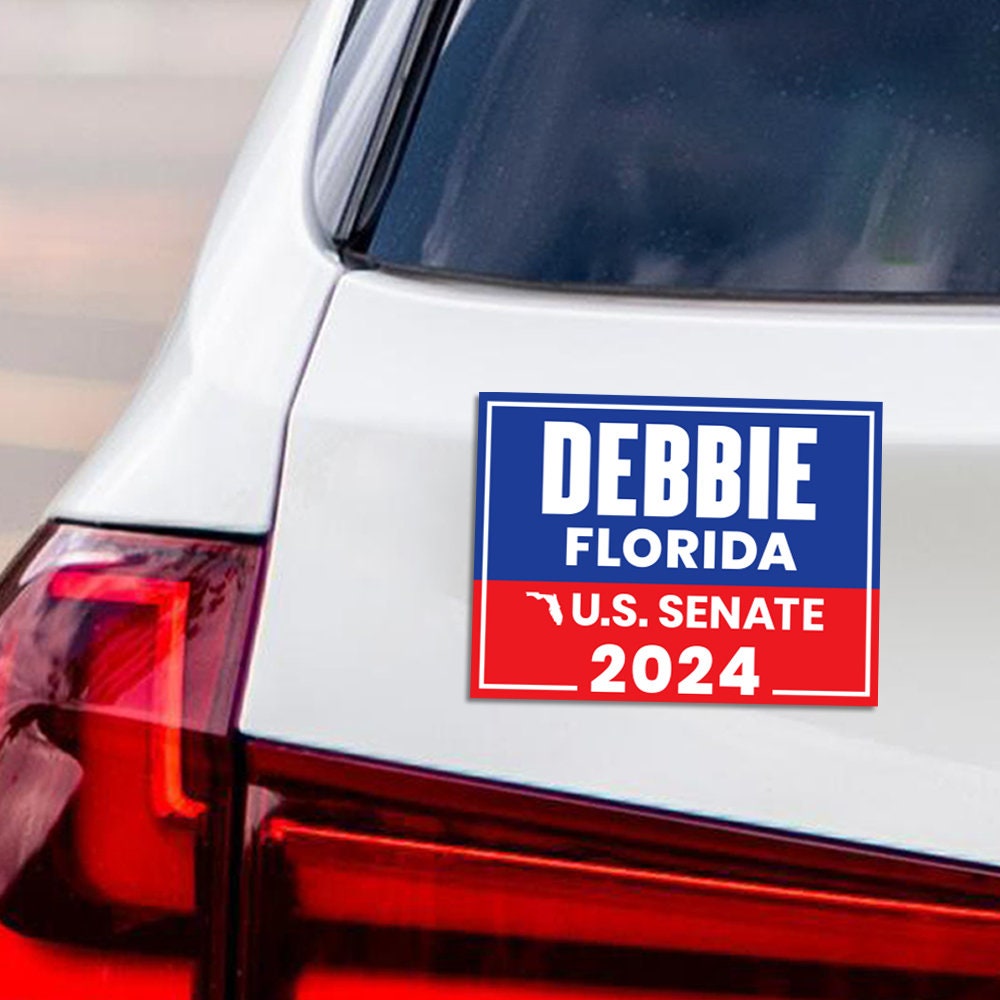 a bumper sticker on the back of a white car