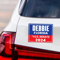 a bumper sticker on the back of a white car