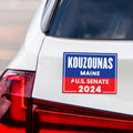 a white car with a red and blue license plate
