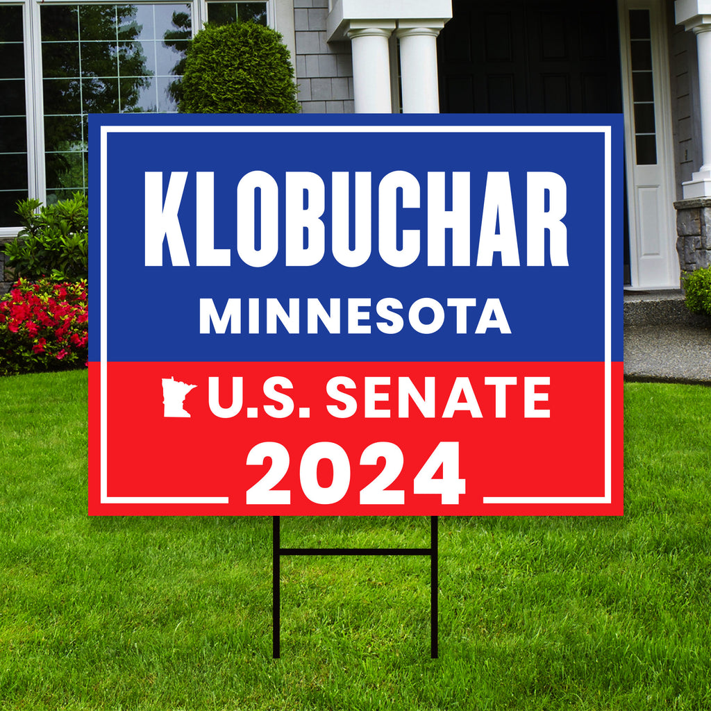 a real estate for sale sign in front of a house