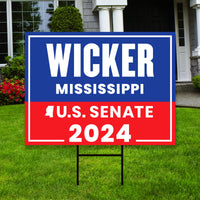 a yard sign with a house in the background