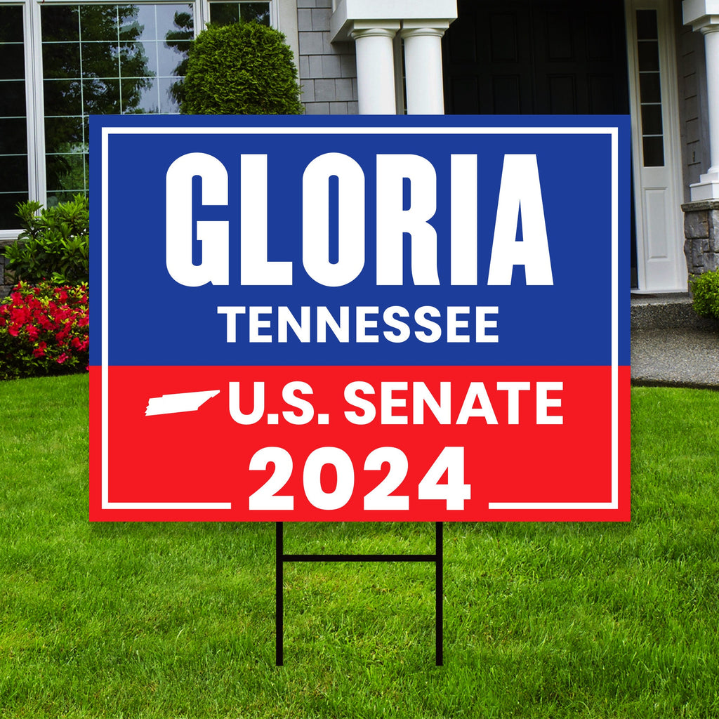a blue and red political sign in front of a house