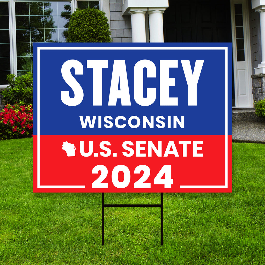 a blue and red political sign in front of a house