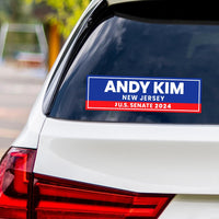 a bumper sticker on the back of a white car