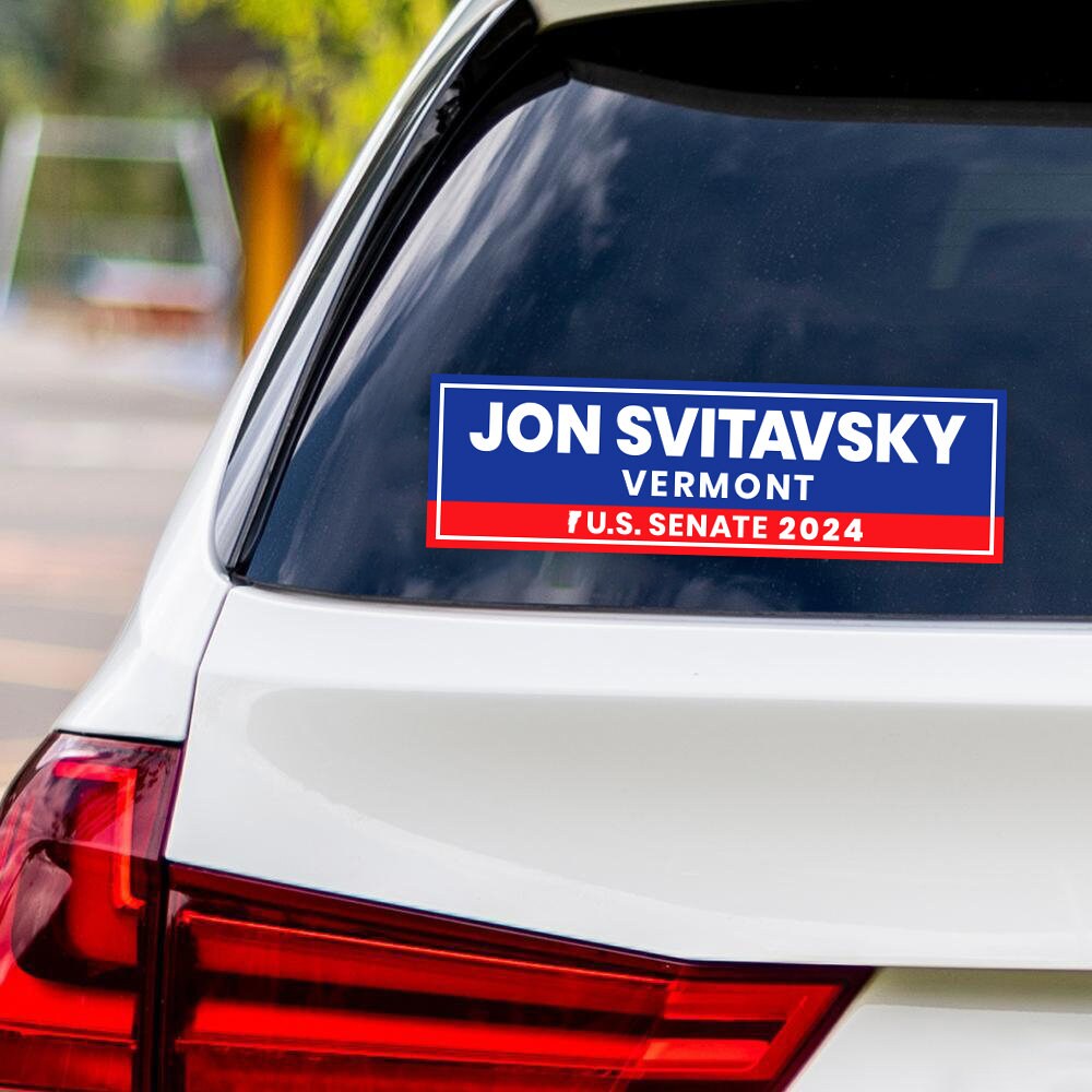 a sticker on the back of a white car